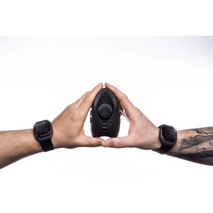 Couple Masturbator Pulse Duo Lux in use with two wrist remote controls held by hands, showcasing its hands-free operation.