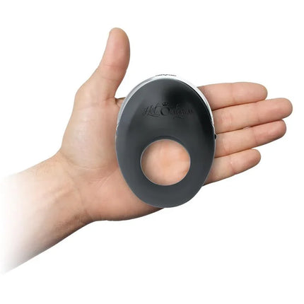 Hand holding Vibrating Penis Ring Atom Black showcasing sleek design