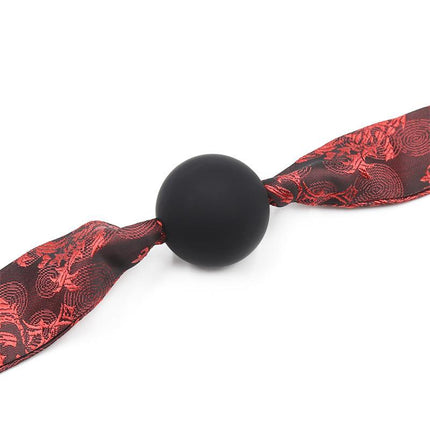 Silicone Ball Gag Red/Black with fabric rope for BDSM play, featuring a comfortable smooth surface and secure restraint design.