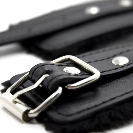 Close-up of Ankle Cuffs with Black Padded Interior 35 cm Black, featuring sleek leather design and silver buckle detail.