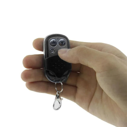 Hand holding remote control for Vibrating Cockring with Remote Control Black