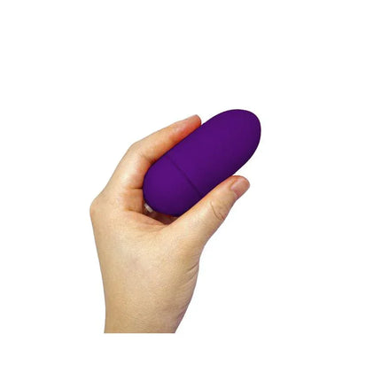 Hand holding Vibrating Egg with Remote Control Dark Purple, highlighting its compact size and sleek design.