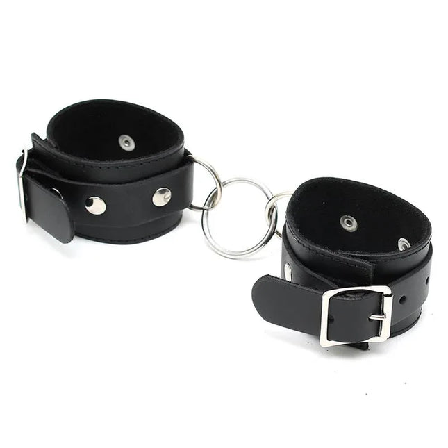 Cuffs Adjustable leather restraints in black with metal ring, suitable for couples' bondage play, featuring adjustable buckles.