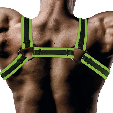 Glow in the Dark Bondage Chest Harness worn on a man's back, featuring neon green straps and soft-touch vegan leather for comfort and style.