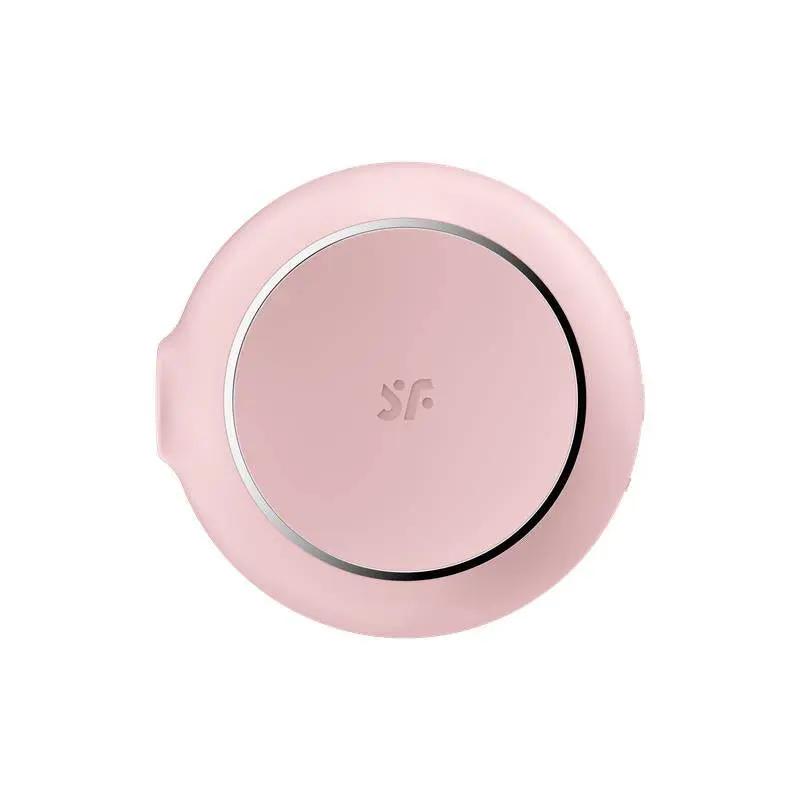 Compact round pink clitoral suction device with silver ring and subtle logo engraving.