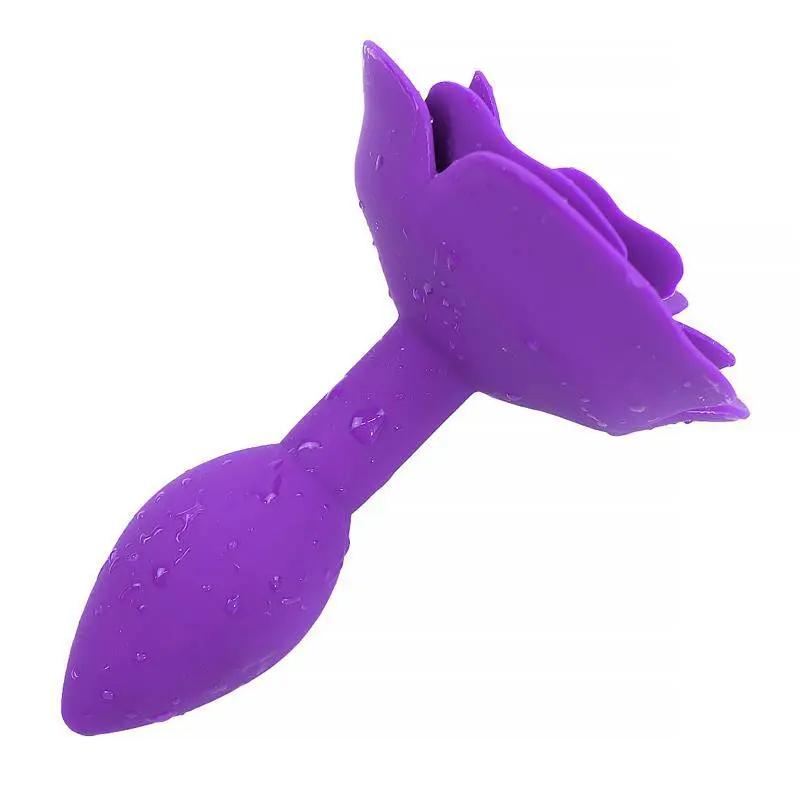Purple silicone butt plug shaped like a rose with textured petals and water droplets.