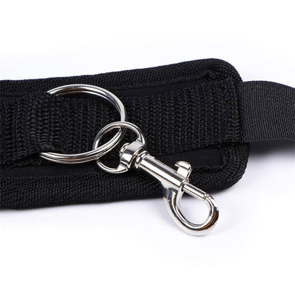 Close-up of black adjustable anklecuffs with suction cups showing velcro strap and metal rings for secure fit.