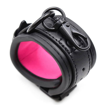 Adjustable Neoprene Handcuffs with pink interior and black finish, perfect for comfortable and secure restraint play.