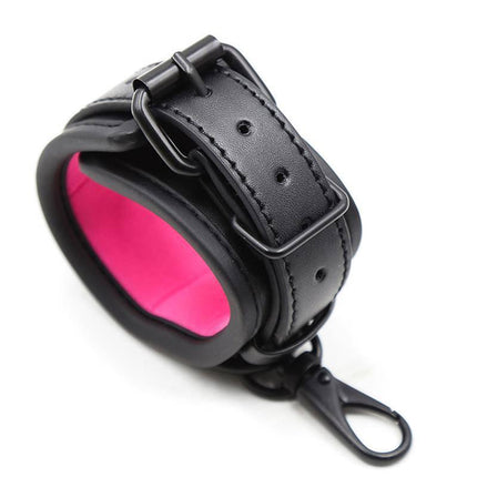 Adjustable Neoprene Handcuffs with black exterior and pink interior, featuring a secure buckle and removable chain for versatile restraint.