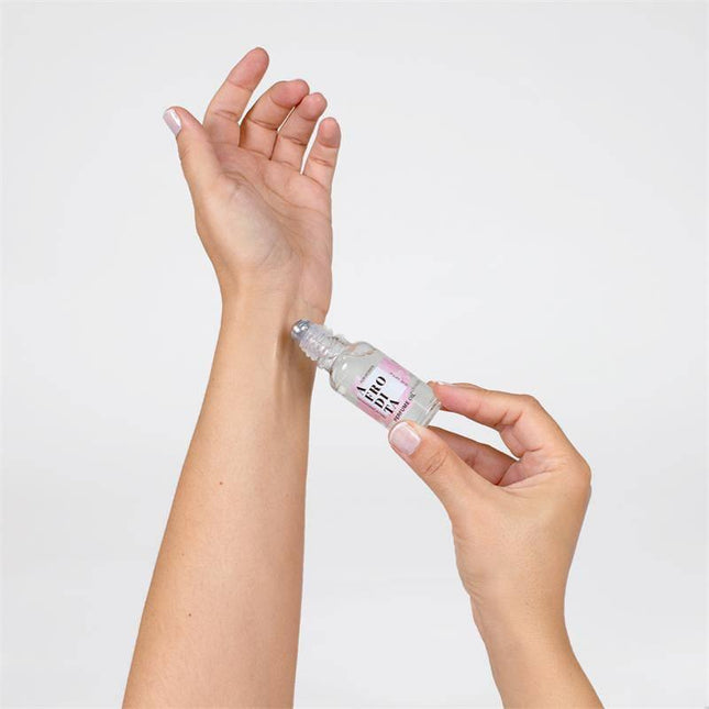 Applying Afrodita Oil Pheromones Perfume 20 ml roll-on to wrist for a confident, alluring scent.