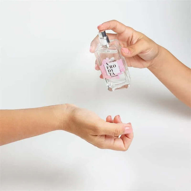 Applying Afrodita Natural Pheromones Perfume Spray 50 ml with a sweet caramel aroma.
