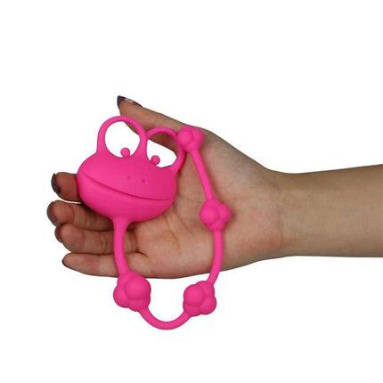 Anal Beads Frog Pink held in hand, featuring flexible and firm silicone design for precise anal stimulation by Psyche Experience.