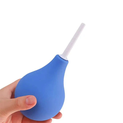 Hand holding Anal Douche Blueb 224ml with ergonomic design and non-toxic materials.