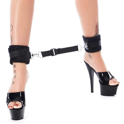 Ankle Cuffs with Adjustable Spreader Strap in use on model wearing high heels, showcasing black durable design and Velcro closure with 30 cm strap.