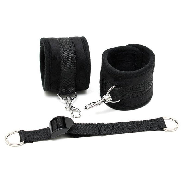 Ankle Cuffs with Adjustable Spreader Strap in black with Velcro closure and karabine hooks, designed for adult restraint.