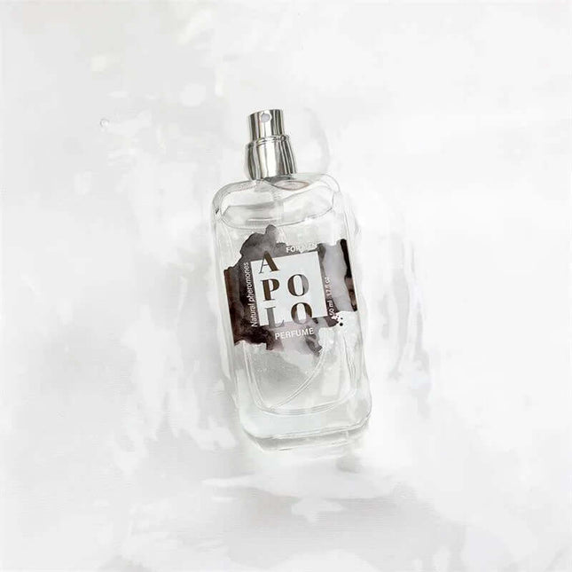 Apolo Natural Perfume with Pheromones Spray 50 ml clear bottle on a white background offering a woody fragrance for men.