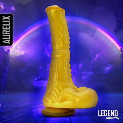 Aurelix Liquid Silicone Dildo 24,5 cm in gold finish with a fantasy-themed background from Lengen Dildos collection.