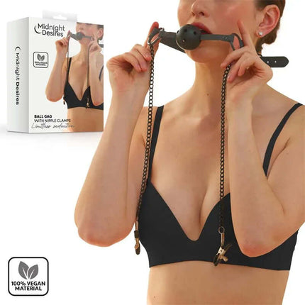 Woman using Ball Gag with Nipple Clamps in black vegan leather set from Midnight Desires packaging.