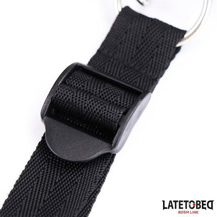Close-up of black adjustable Bed Restraints Adjustable set with buckle and metal ring for secure hold, featured by Latetobed.