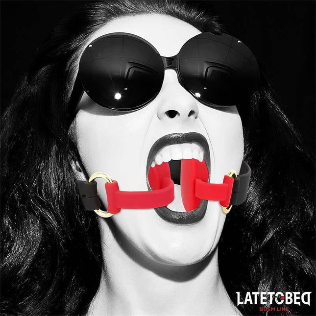 Model wearing the Bendable Force Mouth gag in black and red, showcasing flexible and adjustable features for adult play.