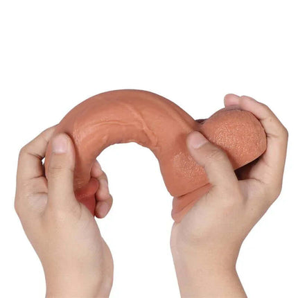 Hands holding Bill Dildo Dual Layer Silicone 8.66" showcasing its flexibility and realistic texture.