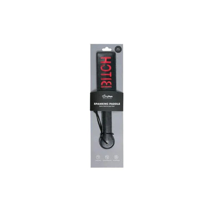 Black Leather Paddle - Bitch with red inscription in packaging, showcasing BDSM accessory for elegant, consensual play.