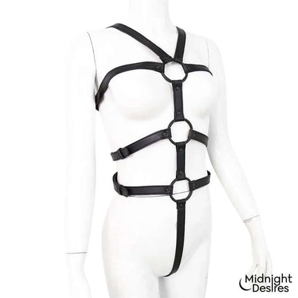 Bondage Body Harness in black vegan leather on mannequin, two-part design with integrated restraints.