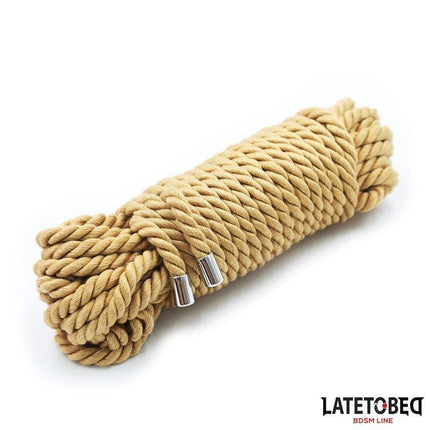 Light brown Bondage Rope with Metal Details 10m, coiled and ready for use, featuring durable nylon with metal accents.