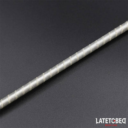 Close-up view of the silver handle of the Bowknot Feather Tickler Paddle on a dark background.