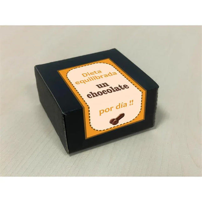 Box with 8 penis-shaped pure chocolates, labeled in Spanish, on a light surface. Perfect for humorous adult occasions.