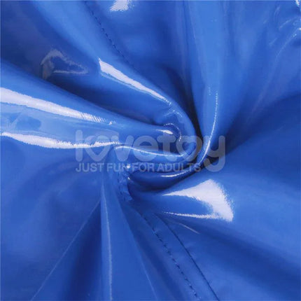 Close-up of shiny blue fabric texture with stitched edges, emphasizing material quality and design.
