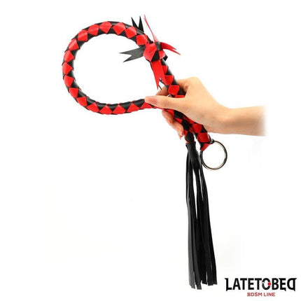 Braided Flogger 85 cm in black and red design, part of the Latetobed BDSM Line, held by a hand for intense sensation play.