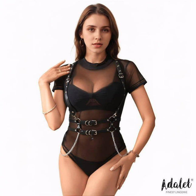 Model wearing Brenda Vegan Leather Harness with Chain One size over mesh lingerie top for bold statement look.