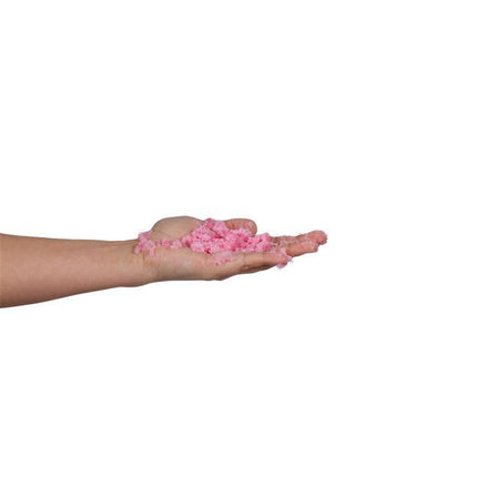 Hand holding pink Bubbling Bath Salts for exfoliation and relaxation