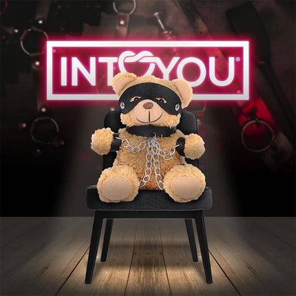 Bubu Keychain BDSM Teddy Bear with Chains sitting on a chair, featuring a playful provocative style with premium vegan leather details.