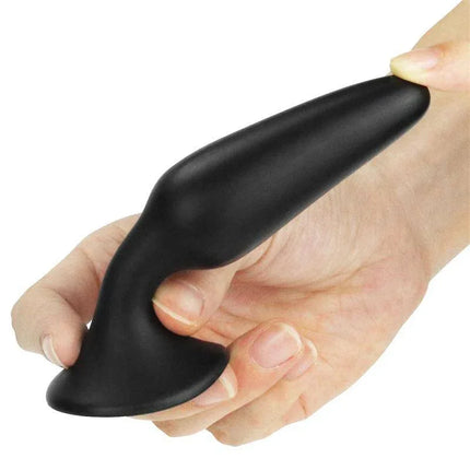 Hand holding the Butt Plug Lure Me Size S Black, a smooth silicone anal plug for beginners.