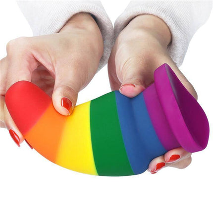 Person holding Butt Plug Prider 6 LGBT, a colorful rainbow silicone anal plug for pride celebration and comfort.
