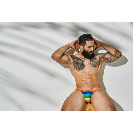 Model wearing C4M03 Classic Thong Rainbow by CUT4MEN, featuring bold rainbow design, made with 75% Polyamide and 25% Elastane.