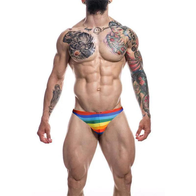 C4M03 Classic Thong Rainbow by CUT4MEN displayed on male model, highlighting colorful design and fit.