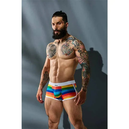 Model wearing C4M06 Athletic Trunk Rainbow by CUT4MEN, showcasing colorful design and ergonomic fit.