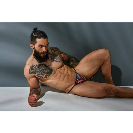 Model wearing C4M12 Briefkini Tattoo by CUT4MEN, showcasing tattoo-inspired design and sleek silhouette for bold style and comfort.