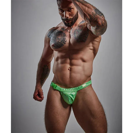 C4M32 Brief / Swimwear Emerald Green modeled by muscular man, highlighting comfort and style in men's swimwear.