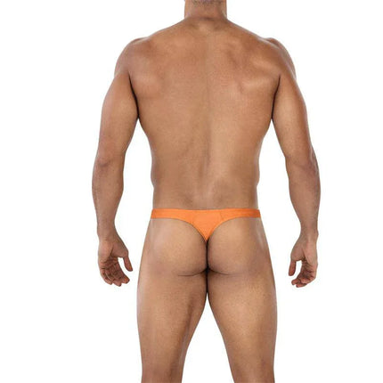 Back view of model wearing C4MSPX06 Brazilian Thong Copper Spring, highlighting vibrant color and Brazilian cut design from CUT4MEN collection.