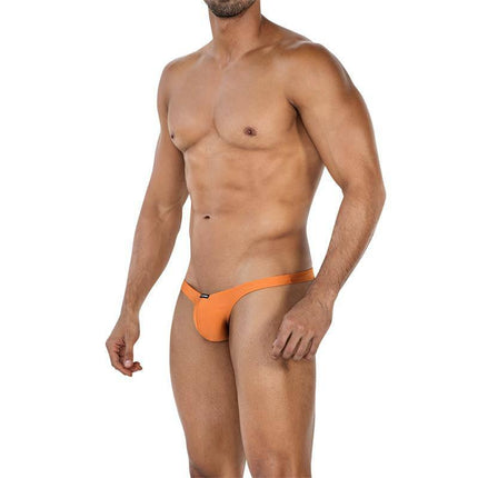 Model wearing C4MSPX07 Slip Capri Copper Spring, versatile slip capri for men, ideal for swimming and lounging, orange color, size variety.