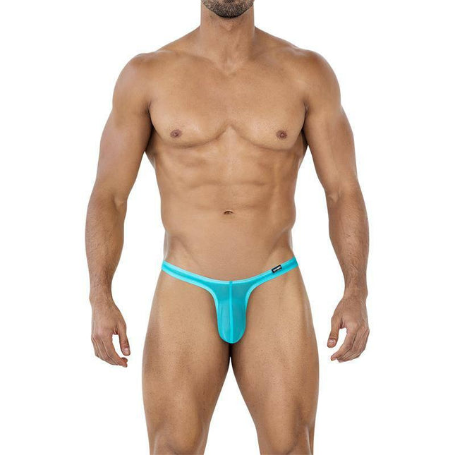 Model wearing C4MSPX11 Micro Thong Turquoise showcasing minimalist and provocative mesh design for men.