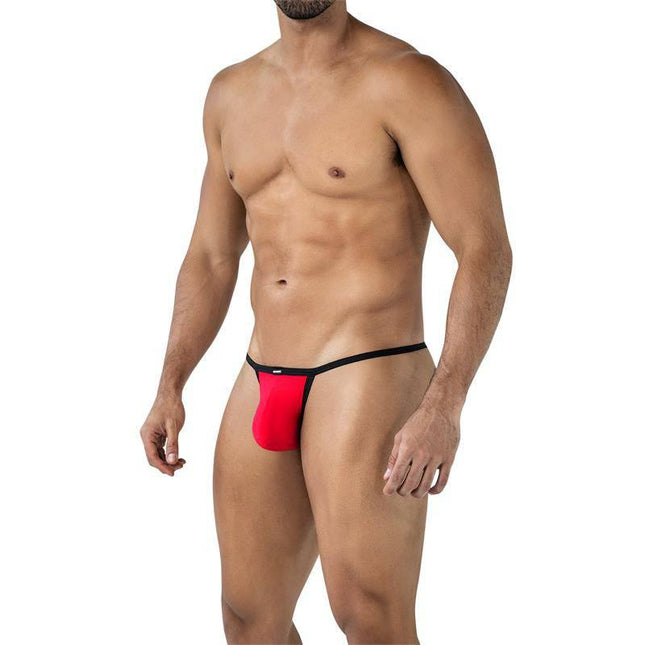 Model wearing C4MSPX17 Mini Tanga Kini Scarlet, a bold men's thong-style underwear in red with black trim for confidence and style.