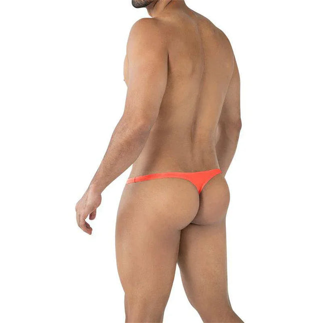 Model wearing C4MSPXBUL03 Micro Thong Tangerine, showcasing minimal rear coverage and ergonomic fit.