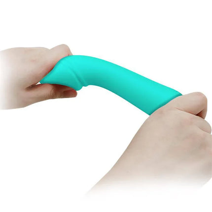 Hands holding a flexible Cetus Vibrator Green showcasing its premium silicone build for G-spot stimulation.