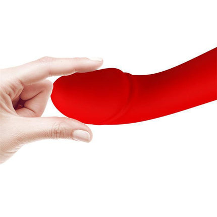 Close-up of red premium silicone Cetus Vibrator Red with a curved tip, designed for targeted G-spot stimulation, held by a hand.