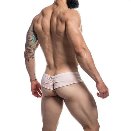 Back view of model wearing Cheeky Brief Provocative Nude by Cut4men, showcasing hybrid thong-slip design for confident wear.